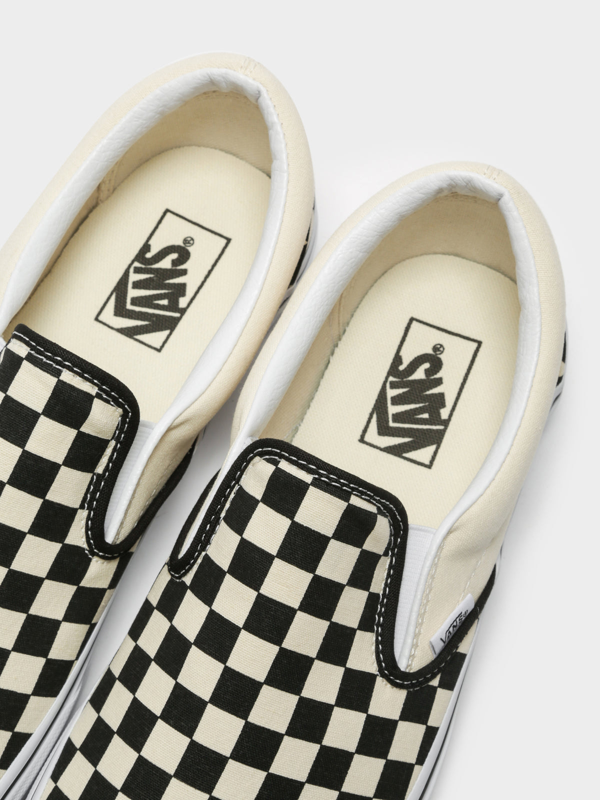 Unisex Classic Slip-On Sneakers in Black and White Checkerboard